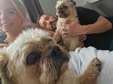 Ryan and Shannon relaxing at home with two small dogs.